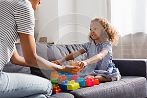 View of nanny giving building blocks