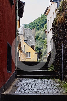 View of the narrow paved street with medieval houses