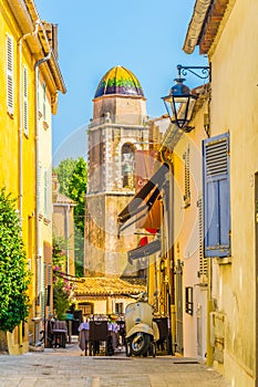 View of a narrow street in the center of Saint Tropez with a Chapelle de la MisÃ©ricorde, France photo