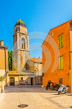 View of a narrow street in the center of Saint Tropez with a Chapelle de la MisÃ©ricorde, France photo