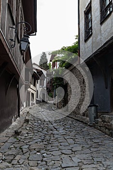 View of a narrow street in  historical part of  Plovdiv Old Town. Typical medieval colorful buildings.