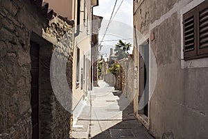 View of narrow street and old buildings in Koper