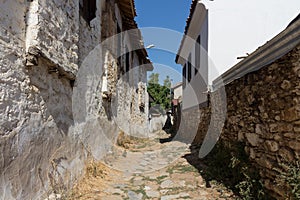 View of narrow street, old historical houses in famous, touristic Aegean mountain village called `Sirince`