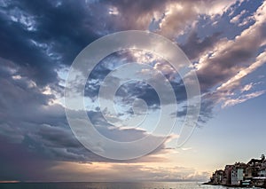 View of narrow stripe of sea and lots of dramatic cloudy sky