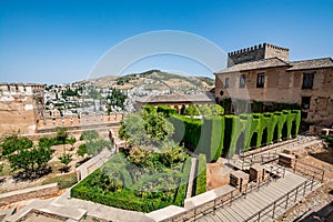 View of the Nasrid Palaces Palacios NazarÃÂ­es and gardens in front of them in Alhambra photo