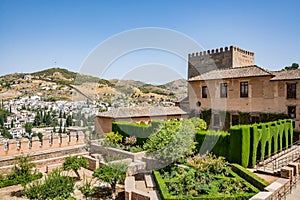 View of the Nasrid Palaces Palacios NazarÃÂ­es and gardens in front of them in Alhambra photo