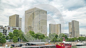 View of the National Library of France timelapse, whose four buildings in the form of open books surround a wooded area.