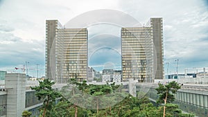 View of the National Library of France timelapse, whose four buildings in the form of open books surround a wooded area.