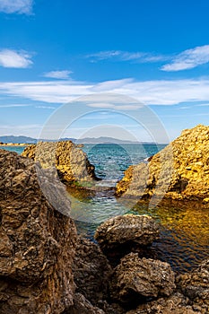 View of the natural arch of the beach of Portitxol in L`Escala, Costa Brava - Girona, Spain photo