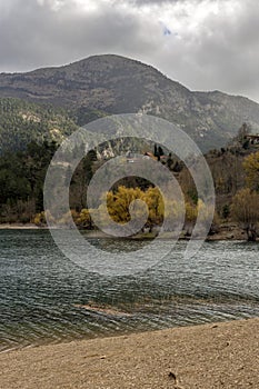 A view of the natural Lake Tsivilu Peloponnesus, Greece and mountains around on a cloudy winter day