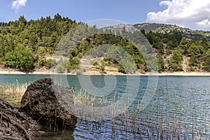 A view of the natural Lake Tsivilu Peloponnesus, Greece and mountains around on a sunny, summer day