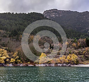 A view of the natural Lake Tsivilu Peloponnesus, Greece and mountains around on a cloudy winter day