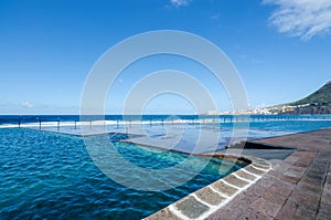 View of natural outdoor swimming pools in the small fishing village Bajamar. Tenerife, Canary Islands, Spain.