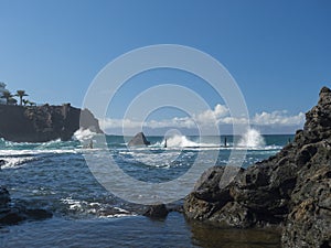 View of natural rock swimming pool Charco de Isla Cangrejo in the Atlantic Ocean in Los Gigantes, Tenerife, Canary islands, Spain