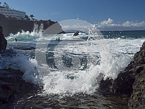 View of natural rock swimming pool Charco de Isla Cangrejo in the Atlantic Ocean in Los Gigantes, Tenerife, Canary islands, Spain