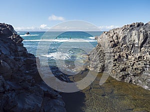 View of natural rock swimming pool Charco de Isla Cangrejo in the Atlantic Ocean in Los Gigantes, Tenerife, Canary photo