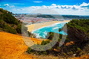 View of Nazare town and the sandy beach seen from high cliff, Portugal