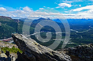 View of Nenana river valley from Mount Healy hike trail with blue sky with white clouds above. Denali National Park