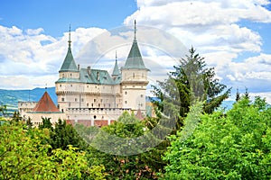 View of neogothic Bojnice castle over treetops of Castle park Bojnice, Slovakia