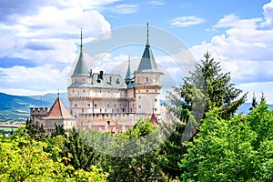 View of neogothic Bojnice castle over treetops of Castle park Bojnice, Slovakia photo