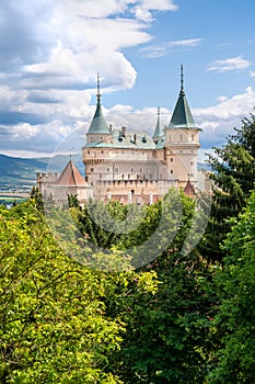 View of neogothic Bojnice castle over treetops of Castle park Bojnice, Slovakia