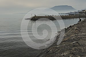 View of Neuchatel lake by beautiful misty sunset