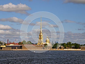 View of the Neva and the Peter and Paul Fortress against a blue sky with clouds. Saint Petersburg