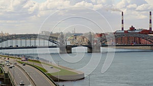 View of Neva river with bridge, buildings and road in Saint-Petersburg city.