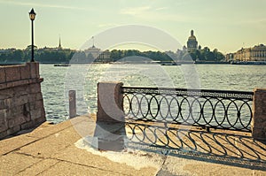 A view of the Neva river and a fragment of the lattice on the University embankment.
