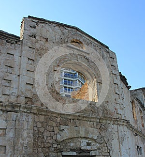 View of the new building through the window of the old house