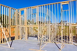 View new home under construction framing of beams stick built building