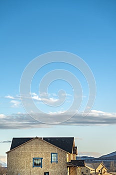 View of new houses under construction under stunning blue sky with clouds