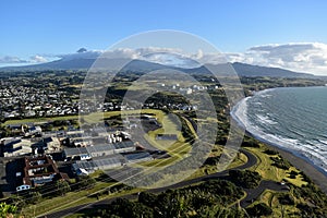 View of New Plymouth town and Mount Taranaki volcano from Paritut Rock scenic peak in New Zealand