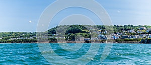 A view from New Quay Bay towards the Bach Quay beach and the outskirts of the town at New Quay, Wales