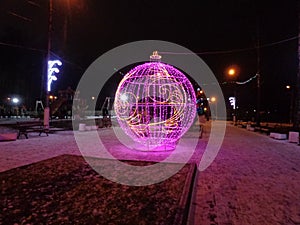 New year street decoration of a spheric form with violet lightning. photo