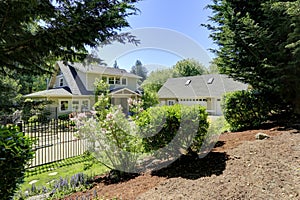 View of nice house with blooming bushes