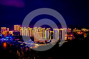 View of the night city of Sanya. Hainan Island, China. Neon lights of the night metropolis. Blur