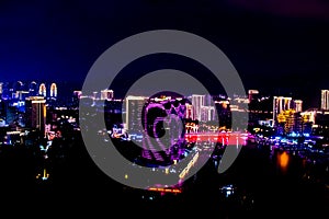 View of the night city of Sanya. Hainan Island, China. Neon lights of the night metropolis. Blur