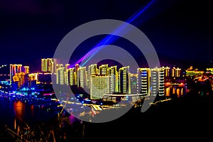 View of the night city of Sanya. Hainan Island, China. Neon lights of the night metropolis. Blur