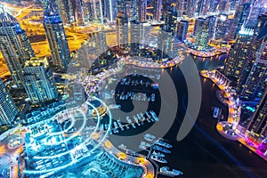 View on night highlighted luxury Dubai Marina skyscrapers,bay and promenade in Dubai,United Arab Emirates