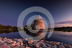 View of the night Pskov Kremlin near the city river on a summer clear day.