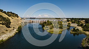 View of nimbus dam at lake Natoma near Sacramento in summer with a few clouds photo