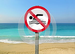 View of a no swimming sign on the beach with calm sea captured on a sunny day