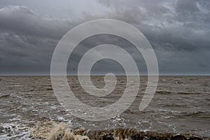 View of the North Sea at Norddeich with dark rain clouds