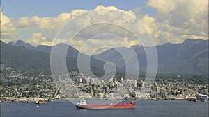 View of North Vancouver BC from Gastown in Canada with Moving Clouds Blue Sky and Water Traffic