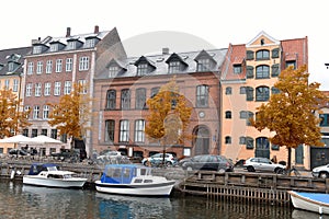 View of Nyhavn pier with color buildings, ships, yachts and other boats in the Old Town of Copenhagen, Denmark