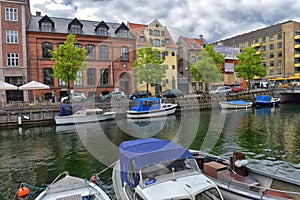 View of Nyhavn pier with color buildings, ships, yachts and other boats in the Old Town of Copenhagen, Denmark