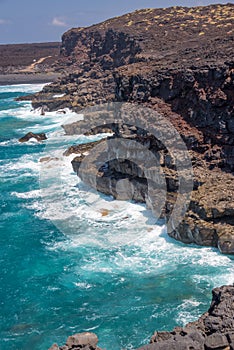 View of the ocean and cliffs on Timanfaya coastal route, a path in the national park of Lanzarote, Canary Islands Spain