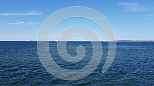 View of the ocean and clouds in the sky. Blue sky with clouds in sunny weather over the ocean.