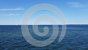 View of the ocean and clouds in the sky. Blue sky with clouds in sunny weather over the ocean.